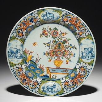 A fine Dutch Delft mixed technique plate with a central flowervase, 18th C.
